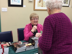image Elaine Cougler selling her books